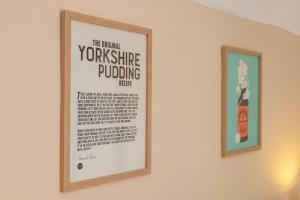 two framed posters on a wall in a room at Pinfold Cottage York in York