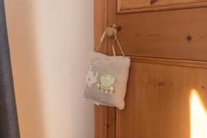 a bag is hanging on a door with a cup at Pinfold Cottage York in York