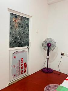 a room with a fan next to a window at Robert Inn Dambulla in Dambulla