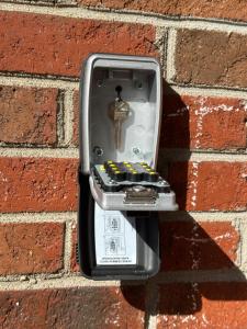 a cell phone hanging on a brick wall at The Trenton Gallery in Trenton