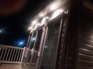 a house with lights on the side of it at night at Luxury caravan in Morecambe