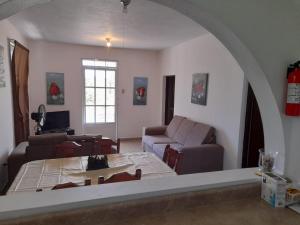a living room with a couch and a table at Coqui del corazón Guest House in Hatillo