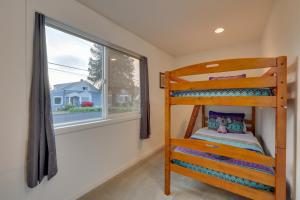 a bedroom with a bunk bed and a window at Chic Port Angeles Home with Oceanfront Balcony! in Port Angeles