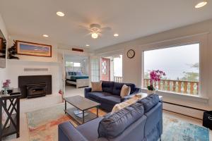 a living room with a couch and a fireplace at Chic Port Angeles Home with Oceanfront Balcony! in Port Angeles