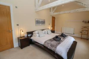 a bedroom with a large bed in a room at The Penthouse in Helston