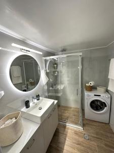 a bathroom with a sink and a washing machine at Comfort inn in Athens +28 photos
