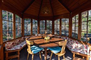 a dining room with a wooden table and chairs at Hotel Haus Biggen in Attendorn