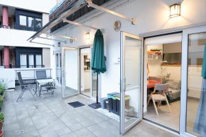 a patio with sliding glass doors and a table at Aldabea II apartamento sostenible in Legazpia