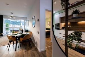 a kitchen and a dining room with a table and chairs at Hedarom in Sinaia