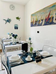 a dining room with a table with plates on it at B&B Il Poeta sul Mare in Ancona