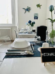 a dining room table with a plate on top of it at B&B Il Poeta sul Mare in Ancona