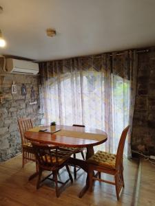 a dining room with a wooden table and chairs at Grange cottages in Edenderry