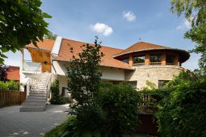 ein großes Haus mit rotem Dach in der Unterkunft KupolaVilla-Apartment-Event house by the Danube river-Buda in Budapest