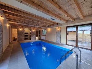 a large swimming pool in a house at Vila Suvo vrelo sa unutrašnjim bazenom i saunom Jahorina in Jahorina