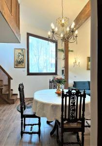 a dining room with a table and chairs and a chandelier at River's house, free parking! in Sofia