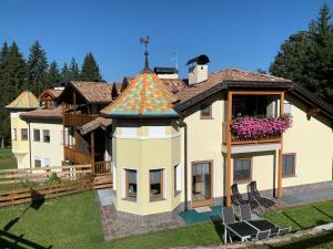 a large house with a roof that has a turret at Obereggen - Anna in Eggen