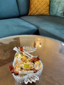 a basket of candy on a glass table at River's house, free parking! in Sofia