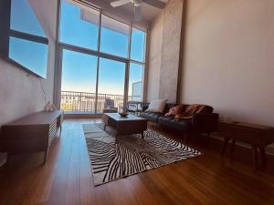 a living room with a couch and a large window at Downtown Oasis Heart Of Austin in Austin