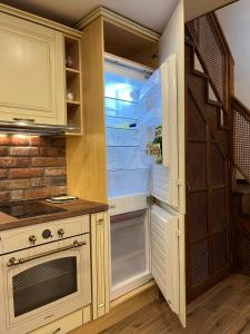 an empty refrigerator with its door open in a kitchen at River's house, free parking! in Sofia +28 photos