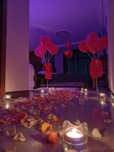 a room with a table with red balloons and candles at Figaro Apartaments in Gdynia