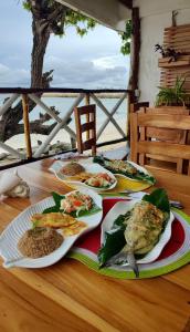 a table with plates of food on top of it at Mira Mira Beach in Cartagena de Indias