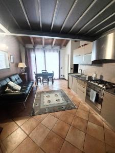 cocina y sala de estar con sofá y mesa en Les Maisons des Fleurs, en San Bartolomeo