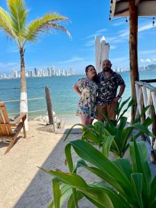 a man and a woman standing on the beach at Mira Mira Beach in Cartagena de Indias