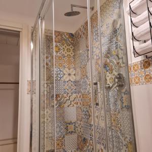 a bathroom with a shower with mosaic tiles on the wall at Mare Fuori B&B in Salerno +45 photos
