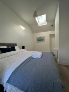 a bedroom with a large bed with a skylight at A Village Gem in Mullingar