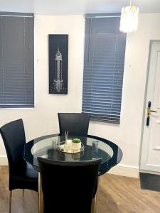 a dining room with a glass table and chairs at Furnished 1 bedroom apartment in Bristol