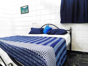 Postel nebo postele na pokoji v ubytování Mannat Inn TS Mysore - Premium Homestay