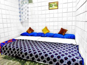 Postel nebo postele na pokoji v ubytování Mannat Inn TS Mysore - Premium Homestay