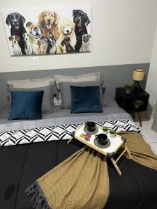 a group of dogs on a bed with a table at Travellar Spot 313B in Ribeirão Preto