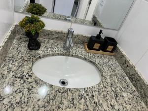 a bathroom counter with a sink with a faucet at Travellar Spot 313B in Ribeirão Preto +14 photos