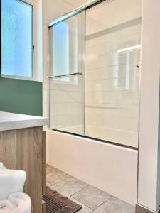 a bathroom with a glass shower and a toilet at Designer Hollywood Penthouse with Private Balcony on Sunset in Los Angeles +15 photos