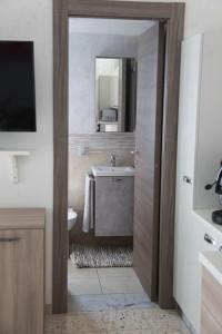een badkamer met een wastafel en een spiegel bij Casa corrado in Sarno