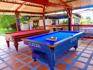 a pool table sitting on top of a patio at Mountain View Hostel in Manizales