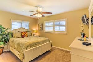 a bedroom with a bed and a ceiling fan at Fort Myers Bungalow - 12 Miles to the Beach! in Fort Myers