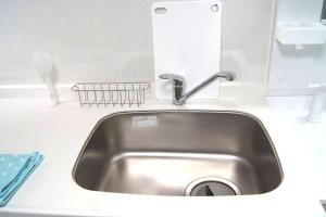 a kitchen sink with a faucet and a mirror at Space Air Building 3F - Vacation STAY 11441 in Tokyo
