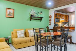 a living room with a table and a couch at Tropical Bliss Pool Wi-Fi BBQ Near Quepos Manuel Antonio in Quepos