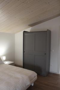 a bedroom with a bed and a wooden ceiling at Guest House Italo & Anna in Pasian di Prato