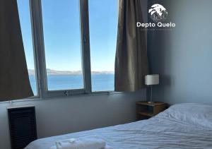 a bedroom with a bed and a large window at Depto. Quelo in San Carlos de Bariloche +1 photo