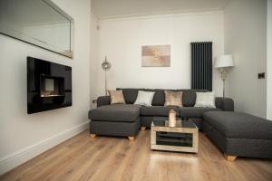 a living room with a couch and a table at Sunny View in Scarborough