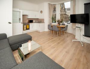 a living room with a couch and a table at Sunny View in Scarborough