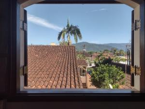 a view of a tile roof from a window at O Paraiso é Aqui ! Casa de Hóspedes in Ubatuba