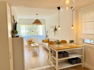 a living room with a couch and a table at Las Brisas 2 by SunHousesCanarias in Las Palmas de Gran Canaria