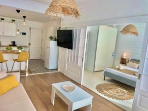 a living room with a couch and a table at Las Brisas 2 by SunHousesCanarias in Las Palmas de Gran Canaria