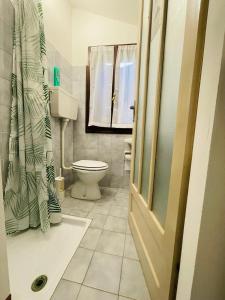 a bathroom with a toilet and a window at Casa del Viandante Borgo dei Sassi di Roccamalatina in Guiglia