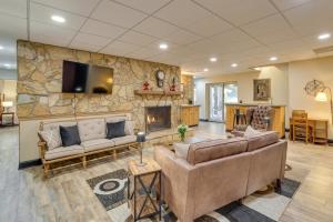 a living room with couches and a stone wall at Pet-Friendly Vacation Rental in Hickory with Pool! in Hickory