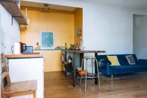 a living room with a blue couch and a table at Peaceful 1BD Flat with Private Garden Brighton! in Brighton & Hove